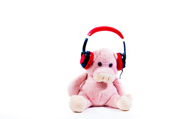 a teddy pig listening to music with headphones