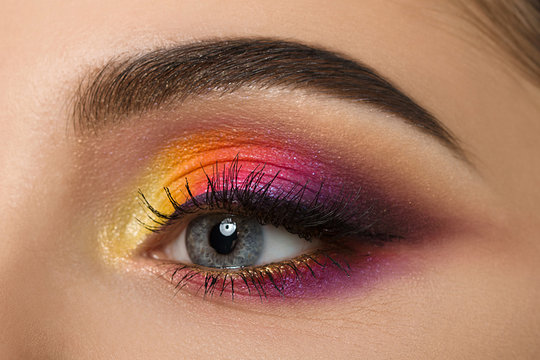 Close-up of woman eye with beautiful colourful makeup