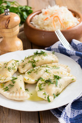  Varenyky on a white plate on wooden table