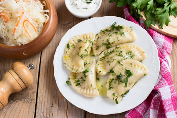  Varenyky on a white plate on wooden table