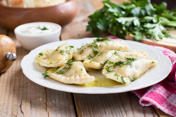  Varenyky on a white plate on wooden table