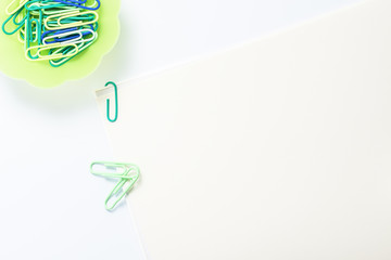 Paper clips.Empty paper on desk.