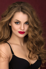 Portrait of coquette young curly woman with red lips