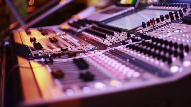 Cool shot of Digital Audio Console by stage during performance
