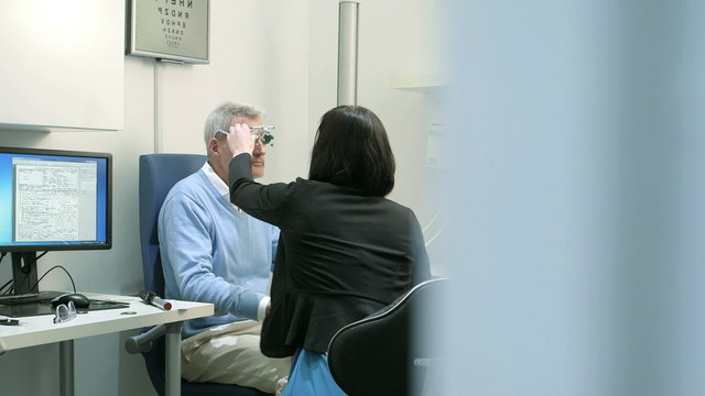 MS Male patient is given instructions by Female Optician