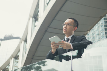 asian businessman with tablet computer on  hong kong central dis