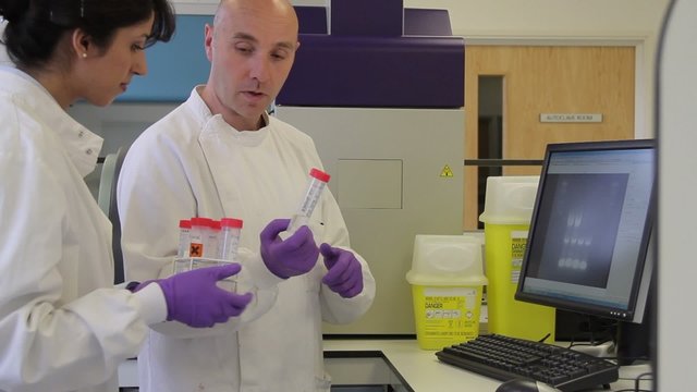 Two Scientist looking at DNA on gel image analyser