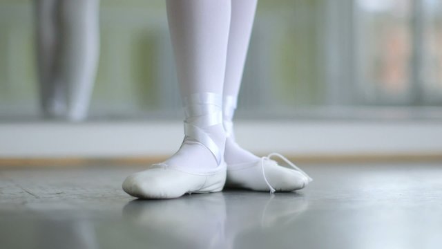 CU A Young Ballerina eases into her soft top Ballet Shoes