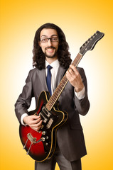 Obraz premium Guitar player in business suit on white