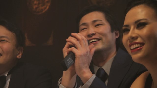 Males and female singing karaoke
