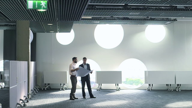 Male architect with blueprint