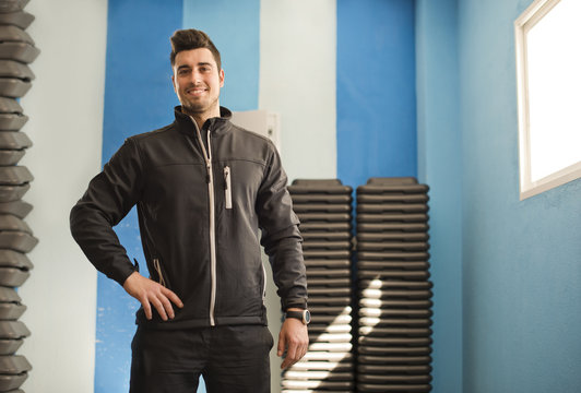 Joven posa en chandal en habitacion de gimnasio