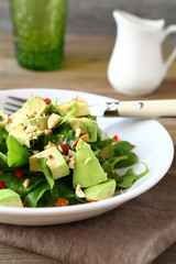 Light salad with spinach and avocado in a bowl