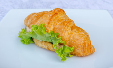 Sandwich croissant with vegetable.