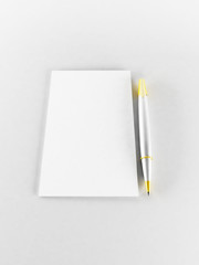 a pen and a paper on the white