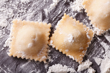 ravioli on a floured table macro. Horizontal top view