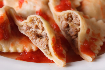 Ravioli stuffed with meat in tomato sauce, horizontal macro