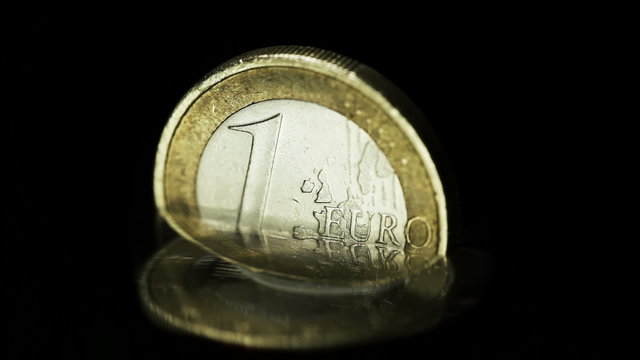 Euro coin in rising water - crisis of the european currency