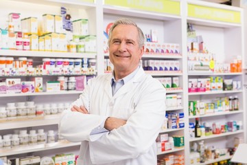 Senior pharmacist with arms crossed
