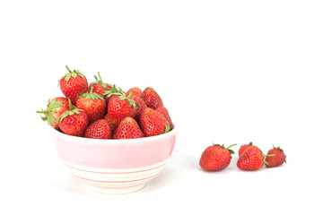 Small white bowl filled with red strawberries