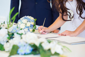 Bride signing wedding license - 79613520