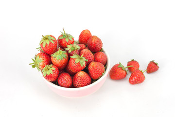 Small white bowl filled with red strawberries