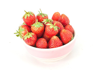 Small white bowl filled with red strawberries