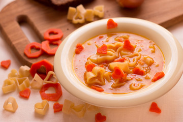 Vegetable soup with Italian pasta in the shape of a heart