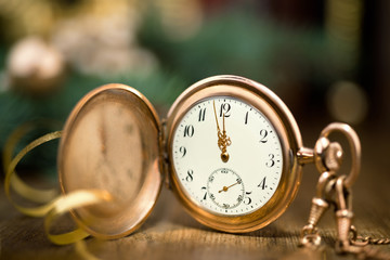 Vintage watch on a festive background showing five to midnight