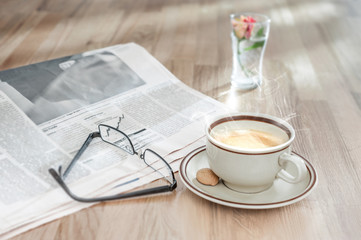 Coffee, muffin and financial newspaper in the morning
