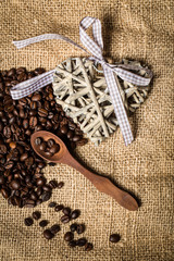 pile of fresh coffee beans, heart and spoon