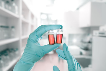 Hands holding scientific samples in modern lab