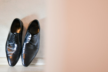 Groom shoes against the wall