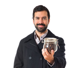 Man holding a jar glass with coffee inside