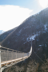 Fototapeta premium Mountain landscape with suspension bridge