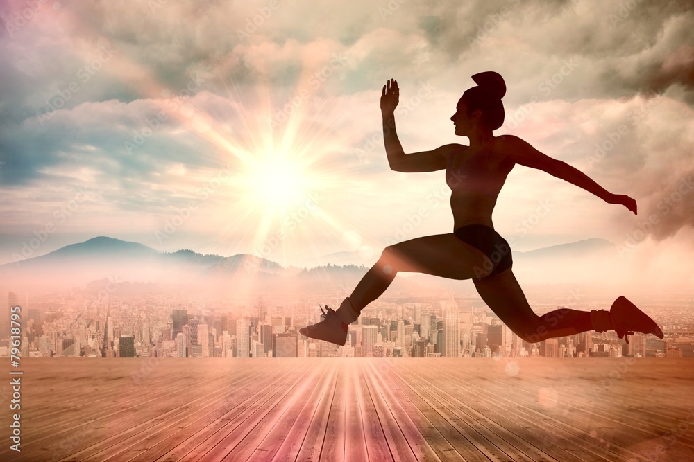 Poster Composite image of fit brunette running and jumping