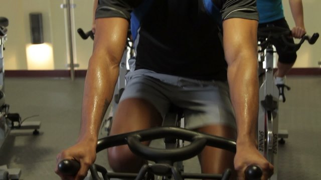 Group working out on bicycles in a gym