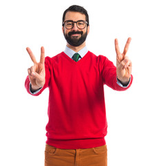 Hipster man doing victory gesture