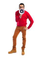 Hipster man shouting by megaphone