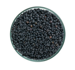 black lentils in a bowl isolated on white