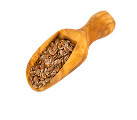 flax seed in a wooden scoop isolated on white