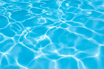 Fototapeta na wymiar Bright water surface in swimming pool