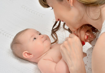 mother tenderly  looking at baby