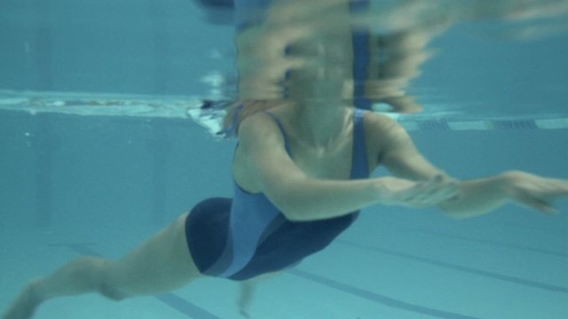 Female swimming in swimming pool in gym