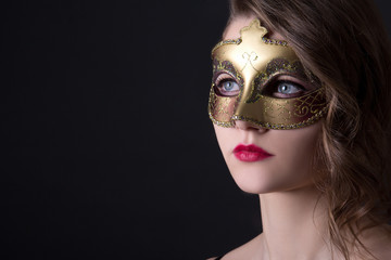close up portrait of beautiful woman in mask over grey