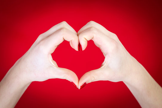 Hands heart isolated on red background