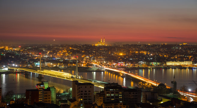 Golden horn of Istanbul at night with mosque skyline