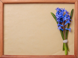 bouquet of blue hyacinths with space for text in a wooden frame