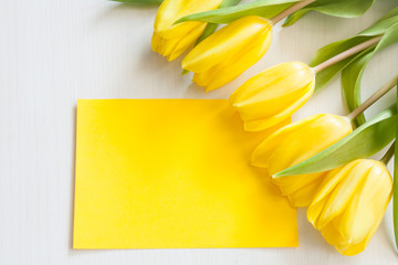 Yellow tulips and blank card