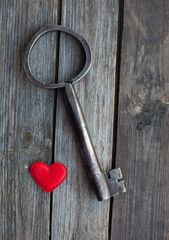 big key and red heart on wooden rustic table